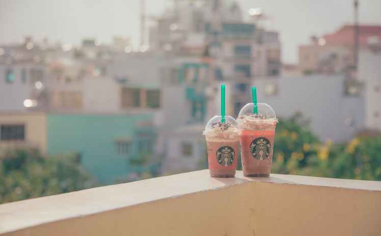 close up photography of two starbucks disposable cups